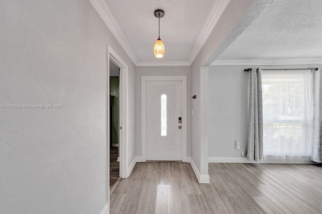 5031 SW 88th Ter, Cooper City, FL 33328 - entryway featuring light wood-style flooring, crown molding, and a textured ceiling