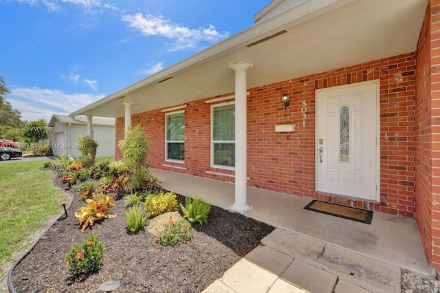 5031 SW 88th Ter, Cooper City, FL 33328 - doorway to property with a porch, brick siding, and a garage