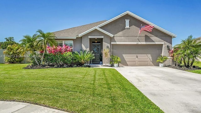 view of front facade featuring an attached garage, driveway, a front yard, and stucco siding