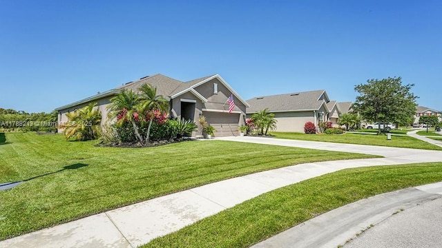 view of front of house featuring a front lawn, driveway, an attached garage, stucco siding, and a residential view