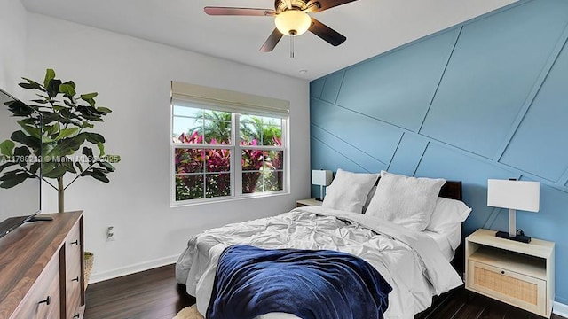 bedroom featuring wood finished floors, baseboards, and ceiling fan