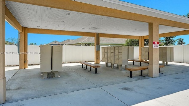 view of patio / terrace with mail area and fence