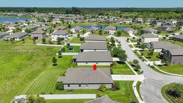 bird's eye view featuring a water view and a residential view