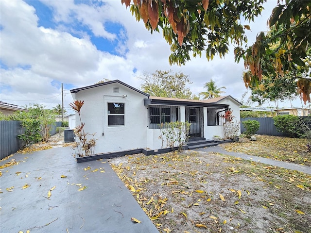 11712 NW 3rd Ave, Miami, FL 33168 - bungalow-style home featuring fence, central AC unit, and stucco siding