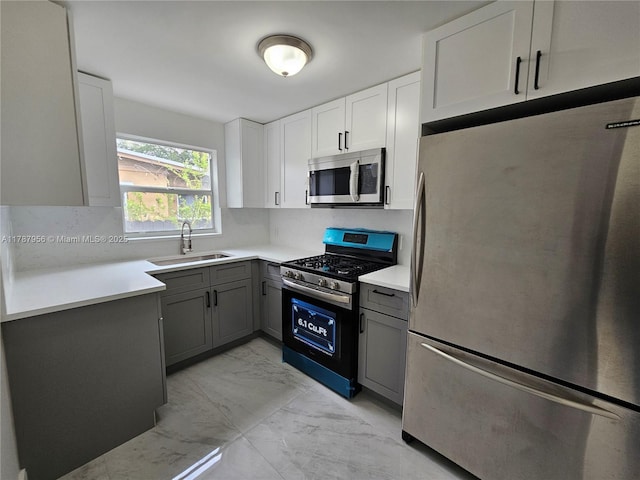 11712 NW 3rd Ave, Miami, FL 33168 - kitchen with a sink, gray cabinets, marble finish floor, light countertops, and appliances with stainless steel finishes
