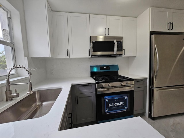 11712 NW 3rd Ave, Miami, FL 33168 - kitchen with white cabinets, appliances with stainless steel finishes, light countertops, and a sink