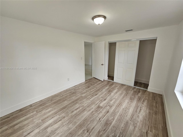 11712 NW 3rd Ave, Miami, FL 33168 - unfurnished bedroom featuring baseboards, visible vents, light wood-type flooring, and a closet