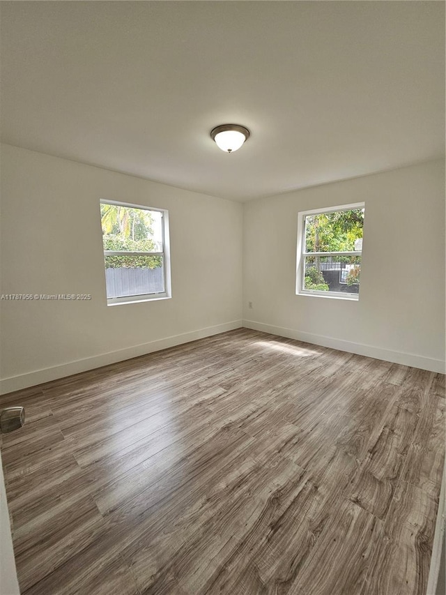 11712 NW 3rd Ave, Miami, FL 33168 - empty room with baseboards and wood finished floors