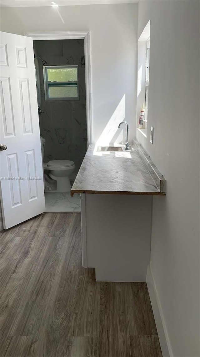 11712 NW 3rd Ave, Miami, FL 33168 - bathroom featuring wood finished floors, a marble finish shower, toilet, and vanity