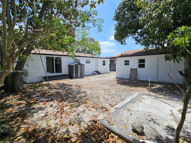11712 NW 3rd Ave, Miami, FL 33168 - rear view of property with an outbuilding and stucco siding