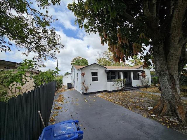 11712 NW 3rd Ave, Miami, FL 33168 - view of front of property featuring central AC, fence, aphalt driveway, and stucco siding