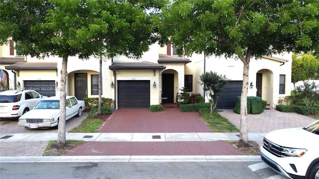 10315 W 32nd Ln, Hialeah, FL 33018 - view of front of property featuring stucco siding, decorative driveway, and an attached garage