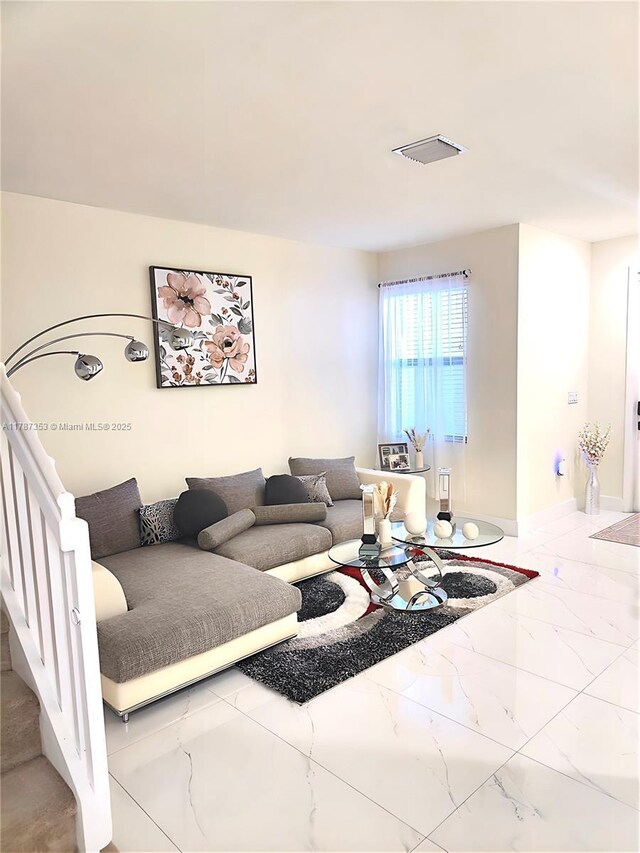 10315 W 32nd Ln, Hialeah, FL 33018 - living area with marble tiled flooring, baseboards, and stairway