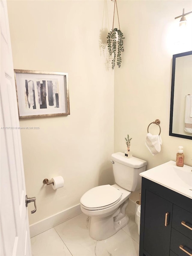 10315 W 32nd Ln, Hialeah, FL 33018 - bathroom with toilet, vanity, baseboards, and marble look tiles