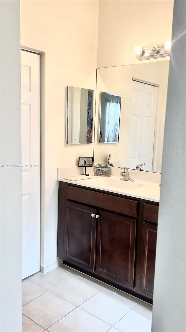 10315 W 32nd Ln, Hialeah, FL 33018 - bathroom featuring double vanity and tile patterned floors
