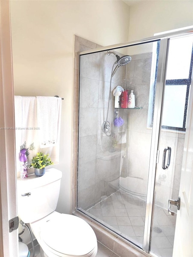 10315 W 32nd Ln, Hialeah, FL 33018 - bathroom featuring toilet and a stall shower