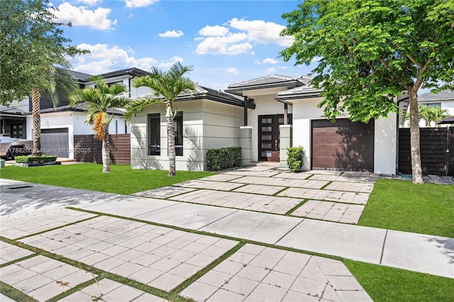 view of front facade featuring stucco siding, an attached garage, a tile roof, concrete driveway, and a front yard
