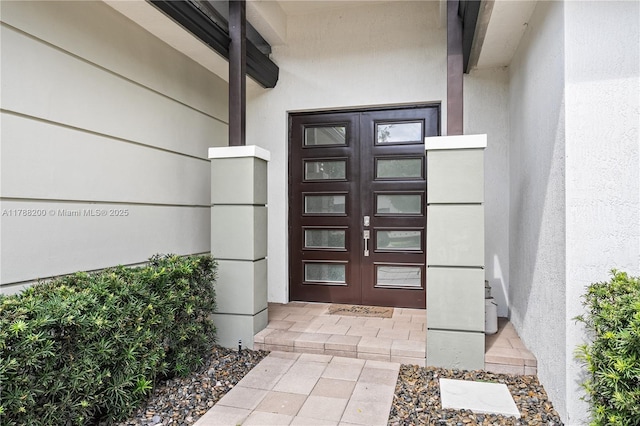 doorway to property with french doors and stucco siding