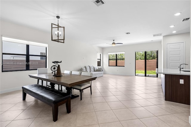 dining area featuring visible vents, a ceiling fan, baseboards, and light tile patterned floors