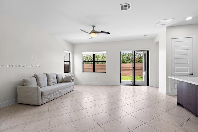 living area with visible vents, baseboards, and light tile patterned floors
