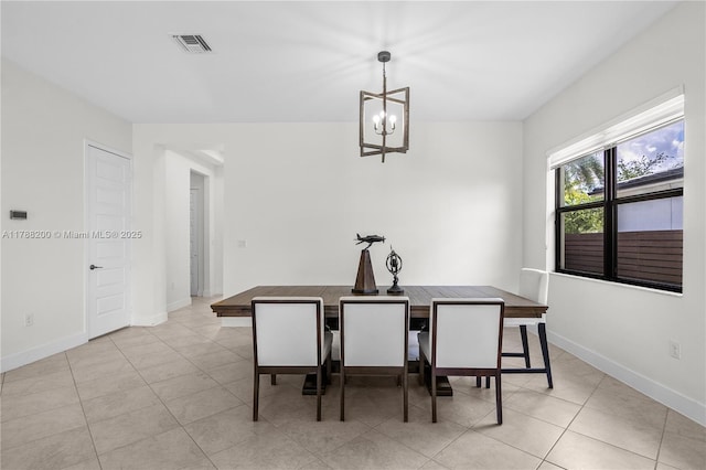 dining area with baseboards, visible vents, a chandelier, and light tile patterned floors