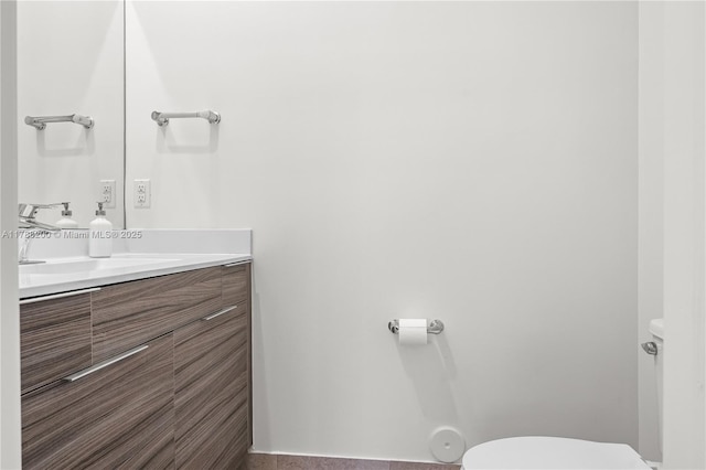 half bath featuring toilet and vanity
