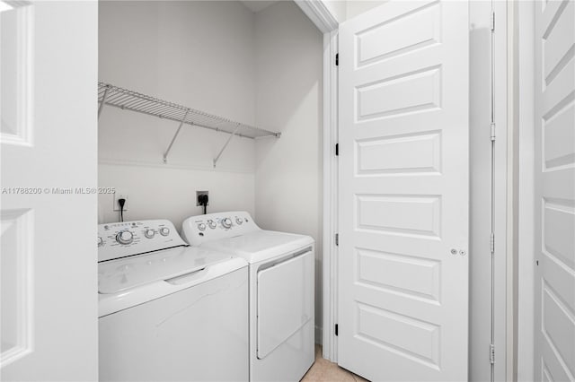 laundry room featuring separate washer and dryer and laundry area