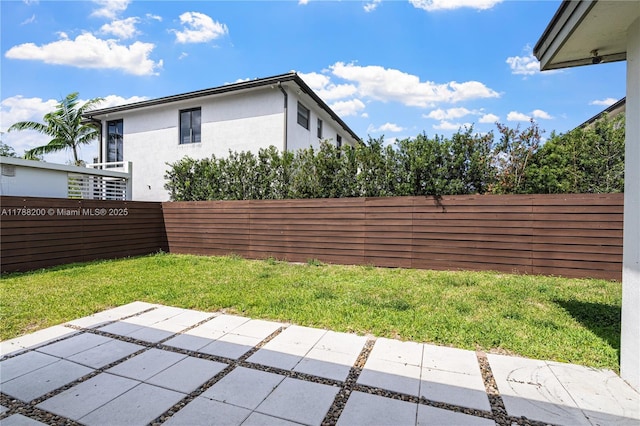 view of yard featuring fence and a patio area