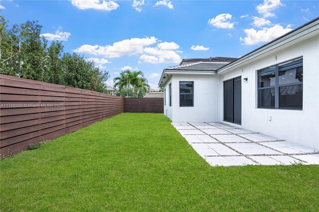 view of yard with a patio and a fenced backyard