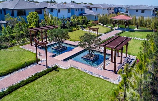 view of community featuring a lawn, a gazebo, and a residential view