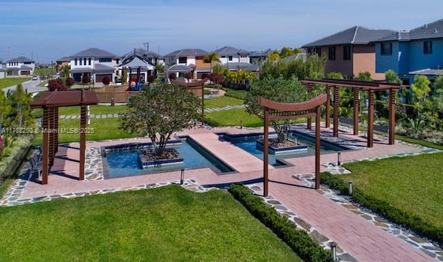 view of swimming pool with a residential view and a lawn