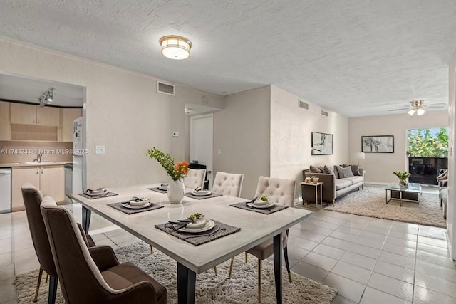 1205 Mariposa Ave Unit 413, Coral Gables, FL 33146 - dining room with light tile patterned flooring, visible vents, ceiling fan, and a textured ceiling