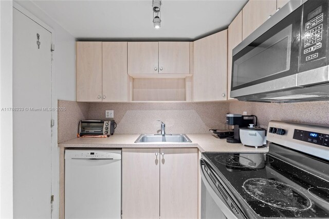 1205 Mariposa Ave Unit 413, Coral Gables, FL 33146 - kitchen featuring light brown cabinetry, stainless steel appliances, light countertops, and a sink