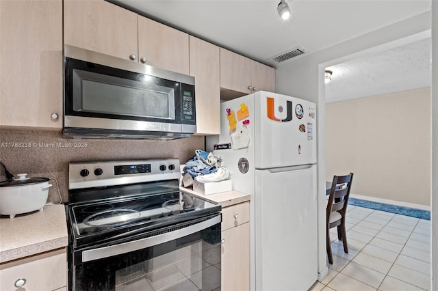 1205 Mariposa Ave Unit 413, Coral Gables, FL 33146 - kitchen with visible vents, light brown cabinets, appliances with stainless steel finishes, and light countertops