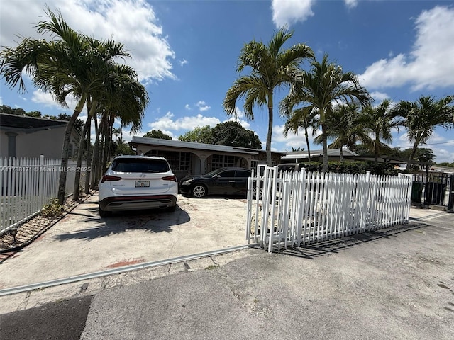 view of front of property with fence private yard and concrete driveway