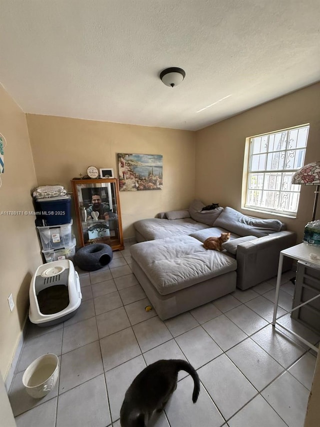 bedroom featuring light tile patterned flooring and a textured ceiling
