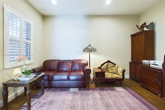 living room with baseboards, wood finished floors, and recessed lighting