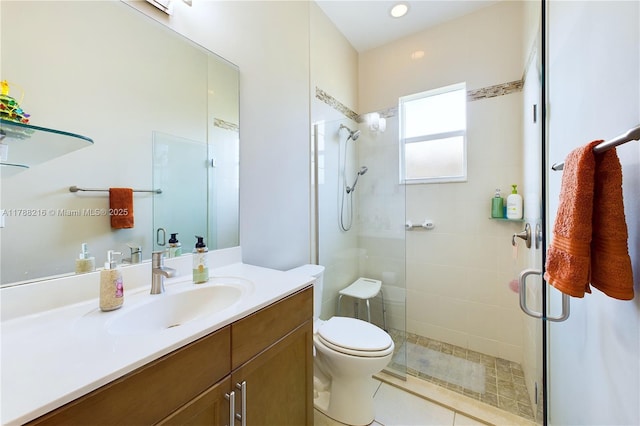 bathroom with a shower stall, toilet, and vanity