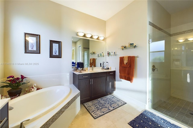 bathroom featuring a bath, vanity, tile patterned flooring, and a stall shower