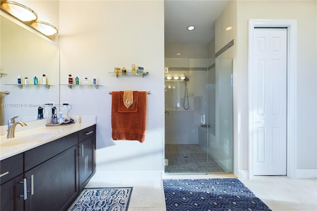 bathroom with recessed lighting, tile patterned floors, vanity, baseboards, and a stall shower