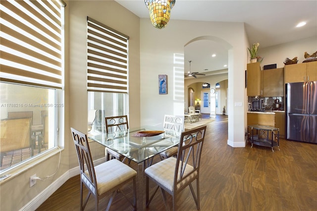 dining space featuring recessed lighting, a ceiling fan, arched walkways, dark wood-type flooring, and baseboards