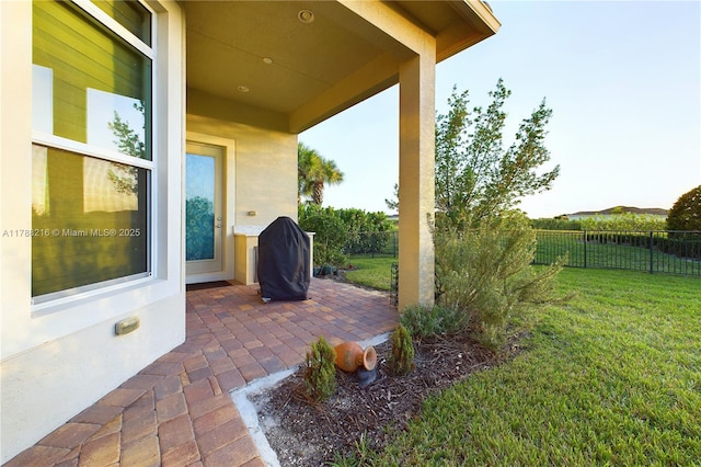 view of patio with fence and area for grilling