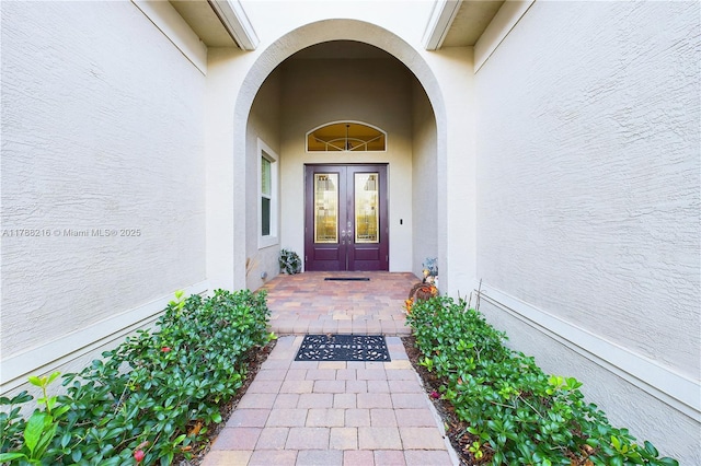 doorway to property with stucco siding and french doors