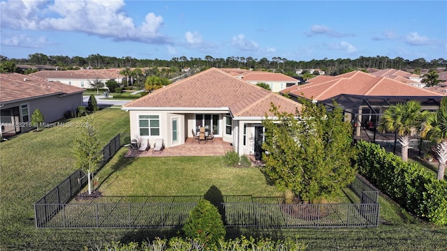 rear view of property featuring stucco siding, a yard, a patio, and a fenced backyard