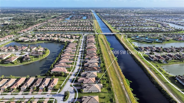 birds eye view of property featuring a water view and a residential view