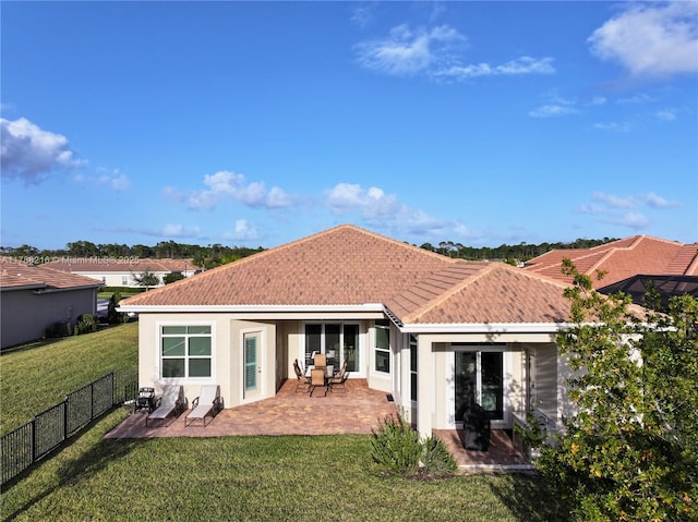 rear view of property featuring a fenced backyard, a tile roof, a patio, and stucco siding