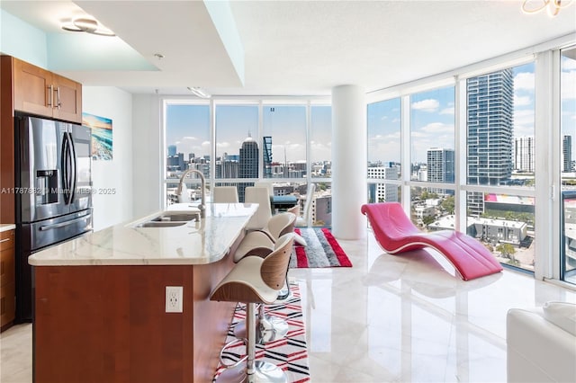 480 NE 30th St Unit 1807, Miami, FL 33137 - kitchen featuring a sink, stainless steel fridge with ice dispenser, light tile patterned floors, a city view, and expansive windows
