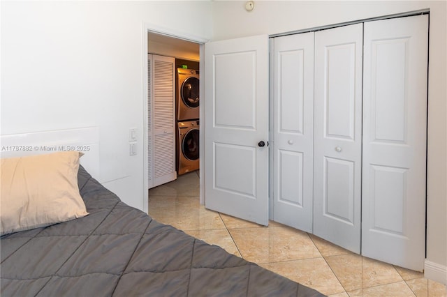 480 NE 30th St Unit 1807, Miami, FL 33137 - bedroom featuring light tile patterned floors, stacked washer and clothes dryer, and a closet