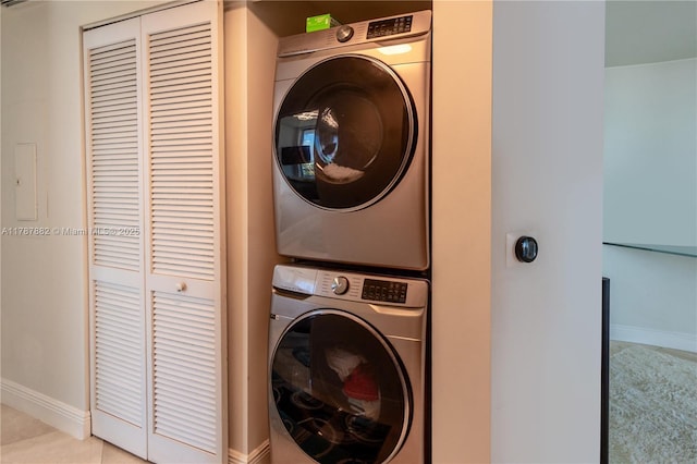 480 NE 30th St Unit 1807, Miami, FL 33137 - washroom featuring baseboards, laundry area, and stacked washer / dryer