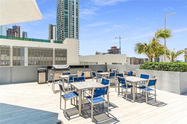 480 NE 30th St Unit 1807, Miami, FL 33137 - wooden terrace with a view of city, outdoor dining space, and a grill